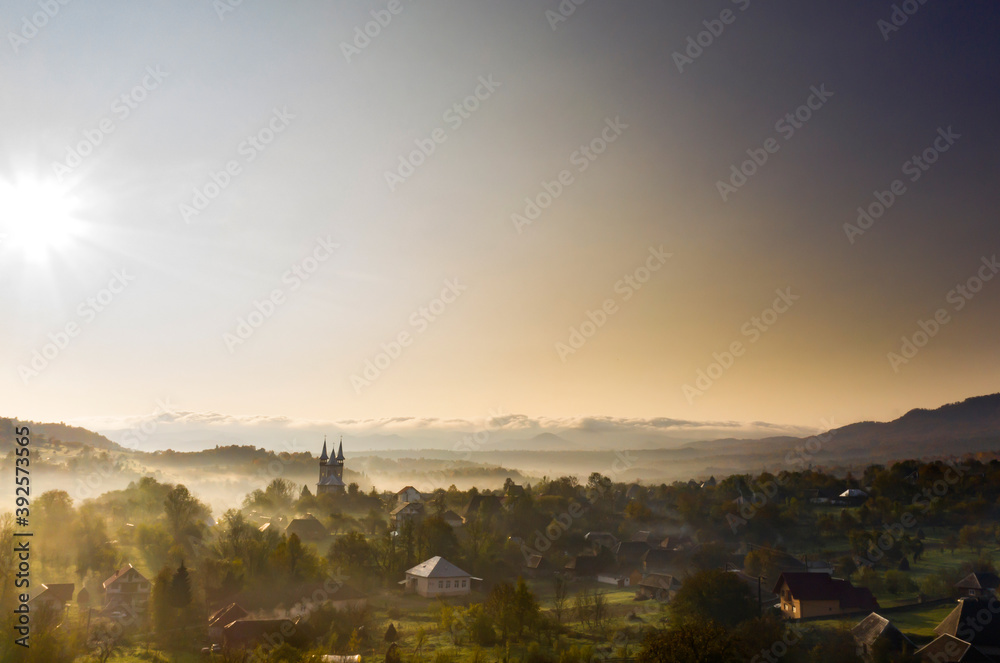 Aerial view over small rural village of Breb in magic sunrise.
