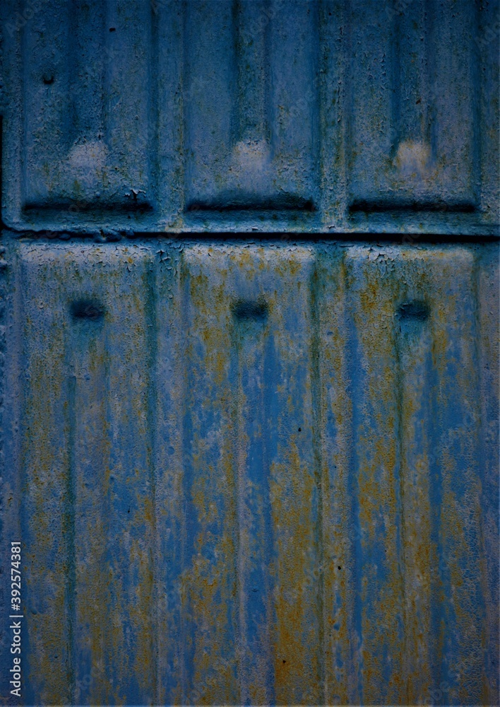the blue paint on the metal doors painted in the background