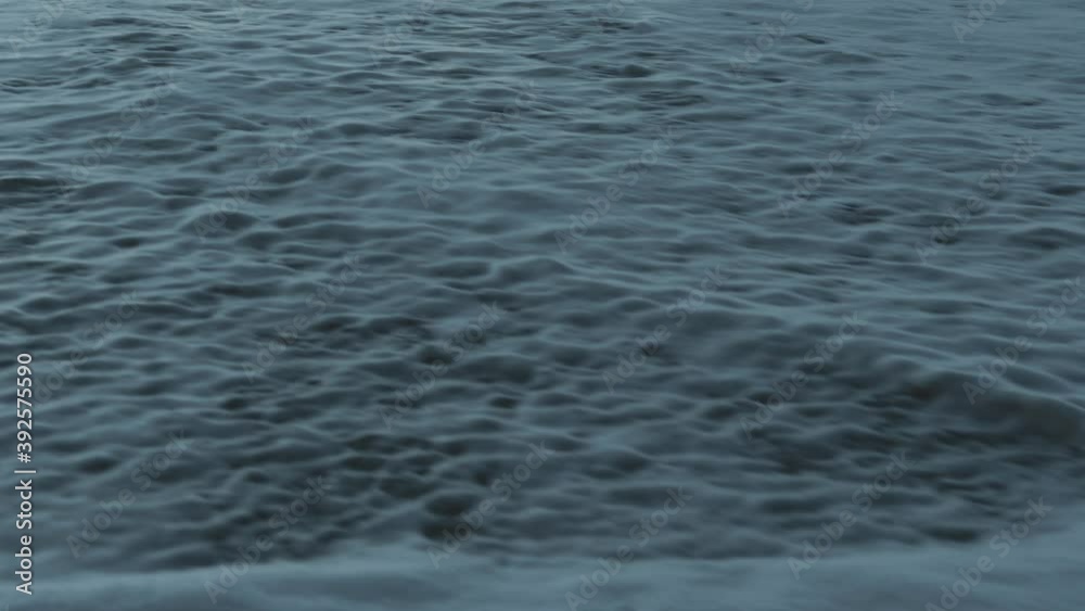 A wave coming up the sand in slow motion 4k