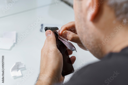 a man changes the protective glass on a smartphone