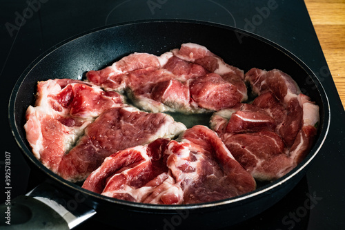Pork steaks in frying pan 
