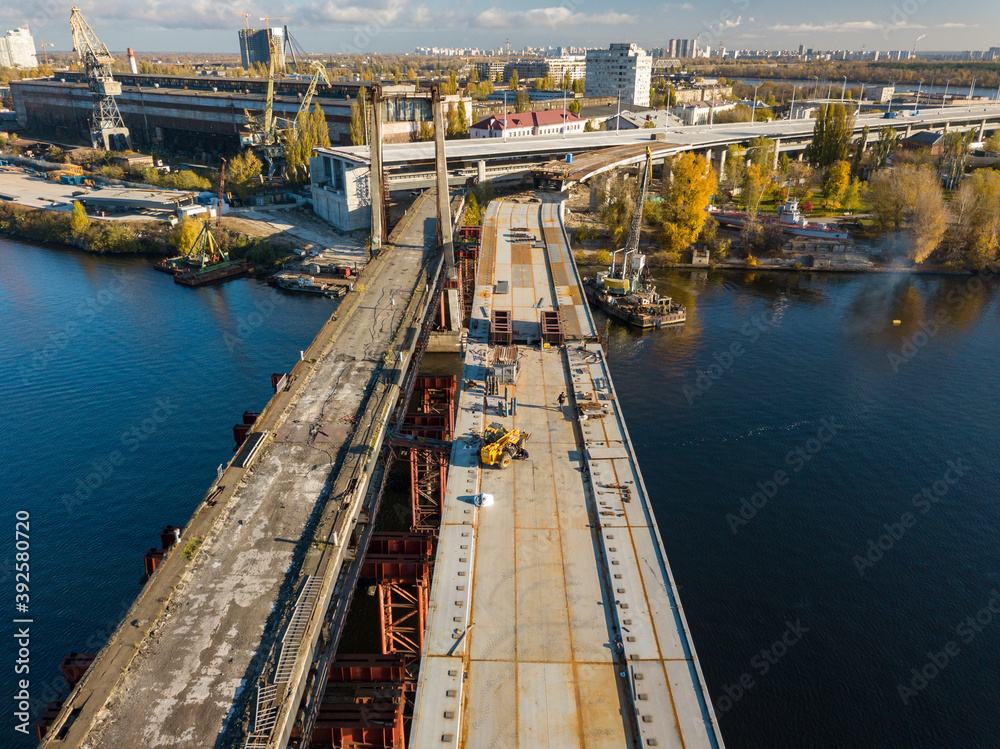 Bridge construction site in Kiev. Sunny autumn morning. Aerial drone view.