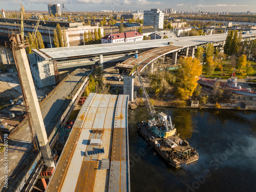 Bridge construction site in Kiev. Sunny autumn morning. Aerial drone view.