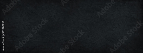 Panel kuchenny z motywem Black background. Dark stone background. Decorative plaster on a concrete wall. Black wide banner. Black rough background with copy space for your design.
