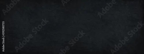 Panel kuchenny z motywem Black background. Dark stone background. Decorative plaster on a concrete wall. Black wide banner. Black rough background with copy space for your design.