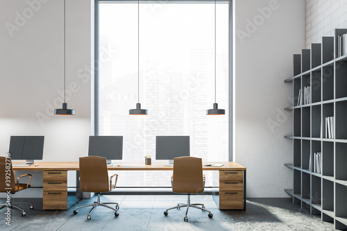 White wooden office with tables and big window, leather chairs and bookshelf