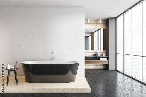 Dark grey bathroom with bathtub and sinks on background  grey floor