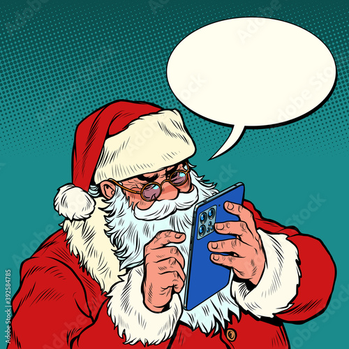 Santa Claus sends messages via mobile tablet. Christmas and New year