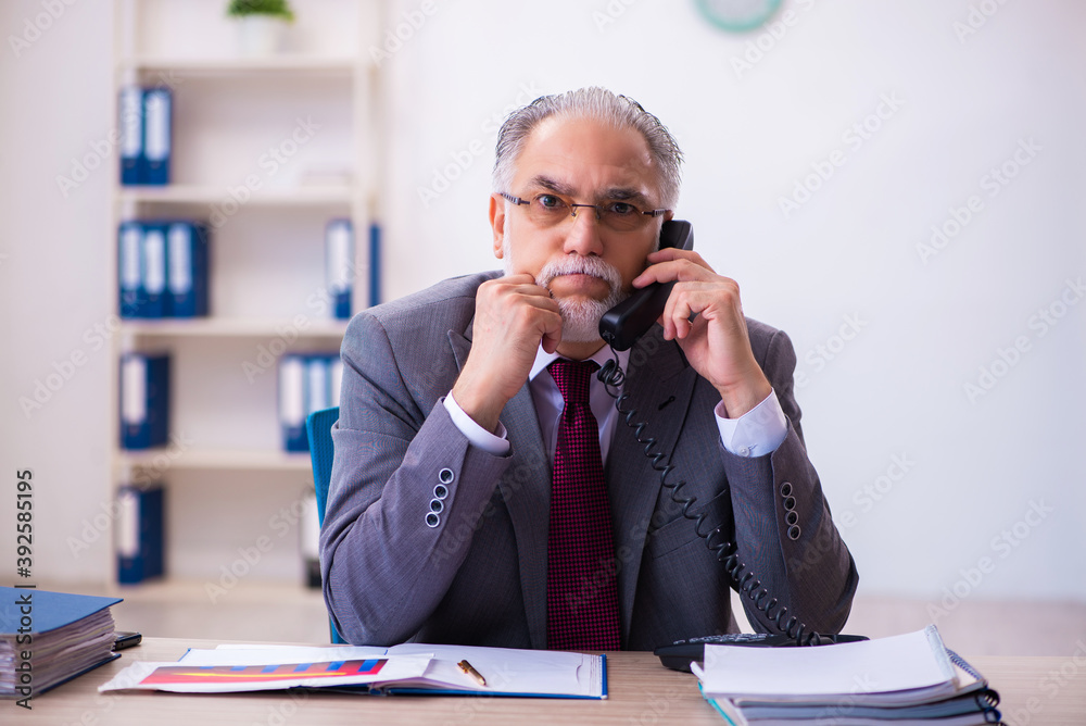 Experienced male employee working in the office Experienced male employee working in the office