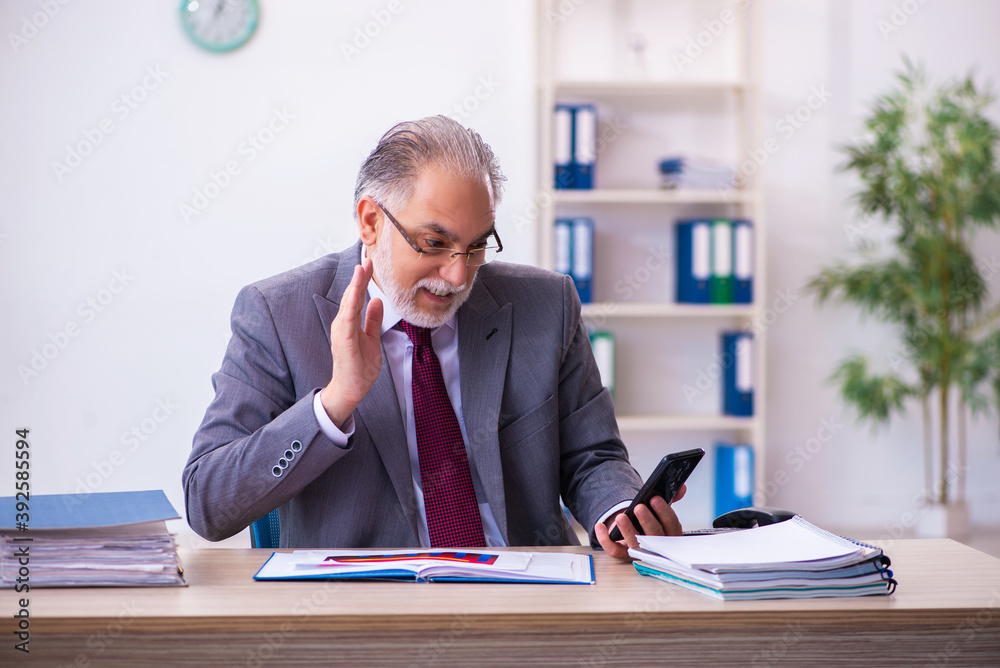 Experienced male employee working in the office Experienced male employee working in the office
