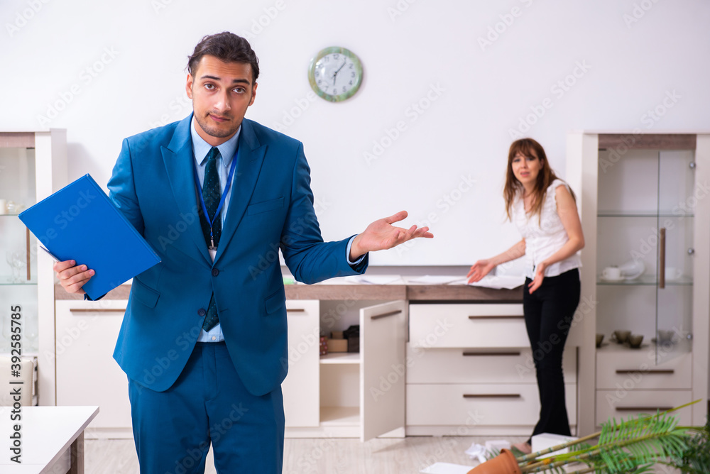 Female owner and male police officer in housebreaking concept Female owner and male police officer in housebreaking concept