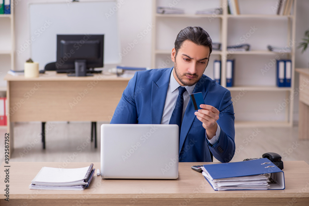 Young male businessman employee working in the office Young male businessman employee working in the office