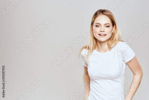 Cute blonde white t-shirt gesture with hands lifestyle light background