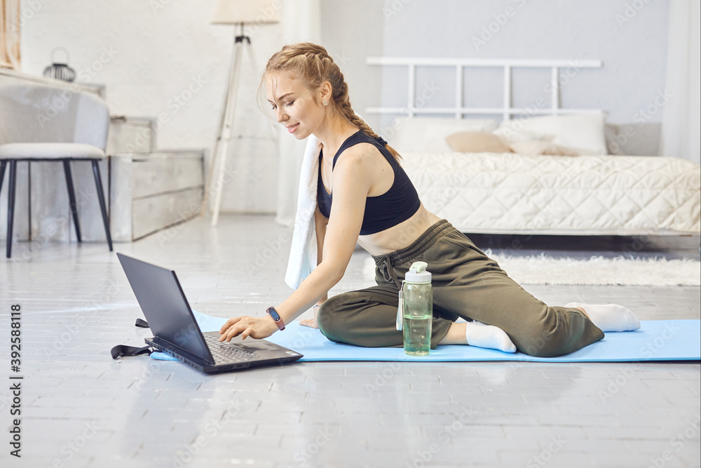 Girl training at home and doing exercise. Fit girl using workout tutorials for healthy active lifestyle. Woman using quarantine for home workouts. Girl training at home and doing exercise. Fit girl using workout tutorials for healthy active lifestyle. Woman using quarantine for home workouts.