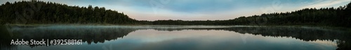 Panorama of a small swamp lake in the morning during sunrise 