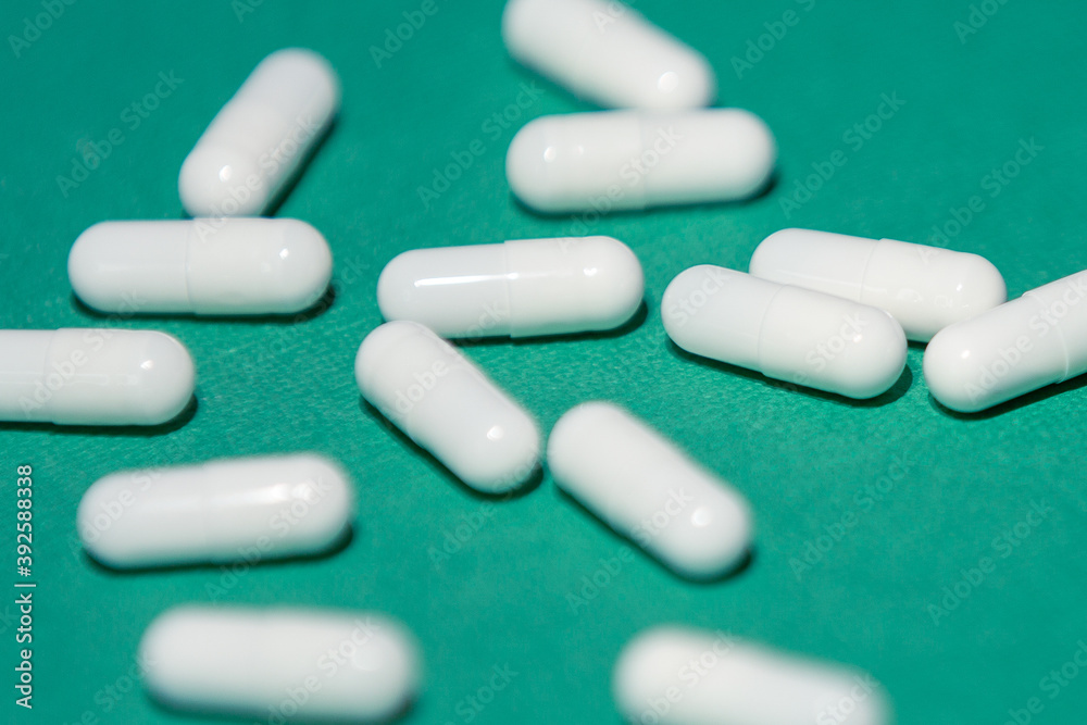 close up. capsules with medicine on a green background. close up. capsules with medicine on a green background.