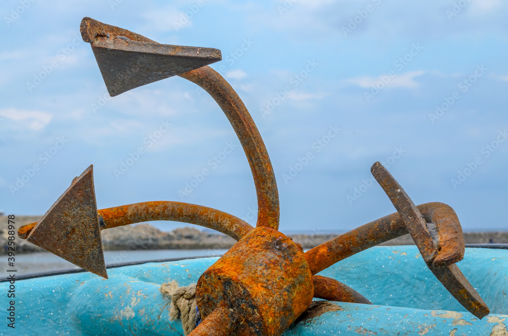 Fototapeta premium Closeup of an old, rusty anchor on an old fishing boat in Muscat, Oman