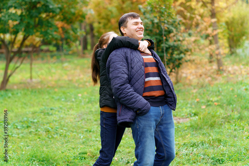 father and daughter walking outdoor in autumn city park, happy people together, parent and children playing and smiling, beautiful nature © soleg