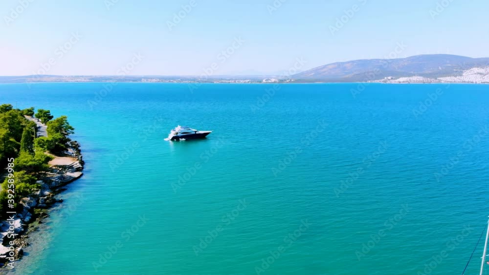 Aerial landscape of green bay of Akbuk with sail boat parking at the middle of Aegean sea in Didim, Turkey Aerial landscape of green bay of Akbuk with sail boat parking at the middle of Aegean sea in Didim, Turkey