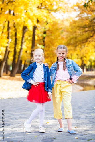 Portrait of two little girls in autumn park