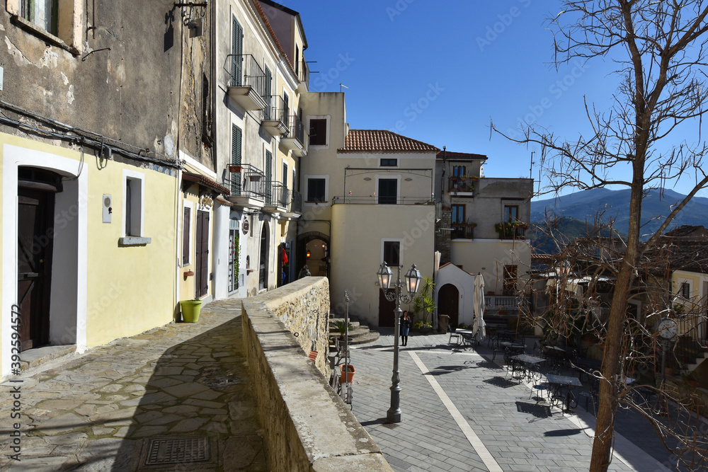Fototapeta premium A narrow street among the old houses of Castellabate, a medieval village in the Campania region, Italy. 