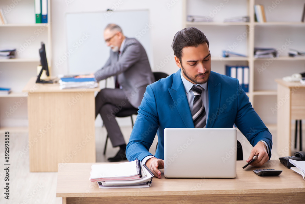Two male colleagues working in the office Two male colleagues working in the office