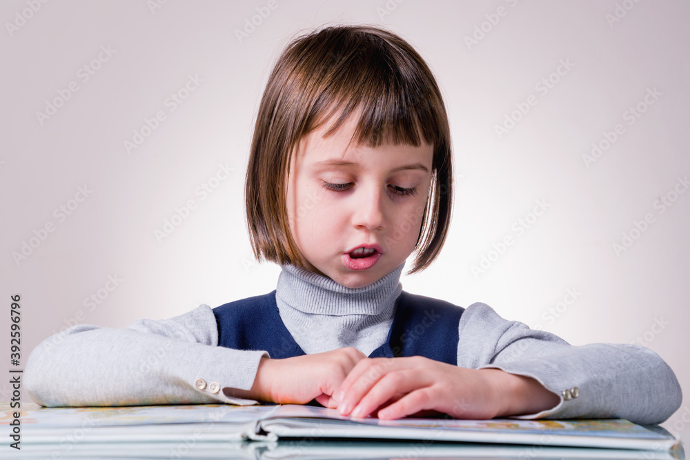Portrait of young beautiful girl reading a book. Learning, science, knowledge and development concept. Portrait of young beautiful girl reading a book. Learning, science, knowledge and development concept.