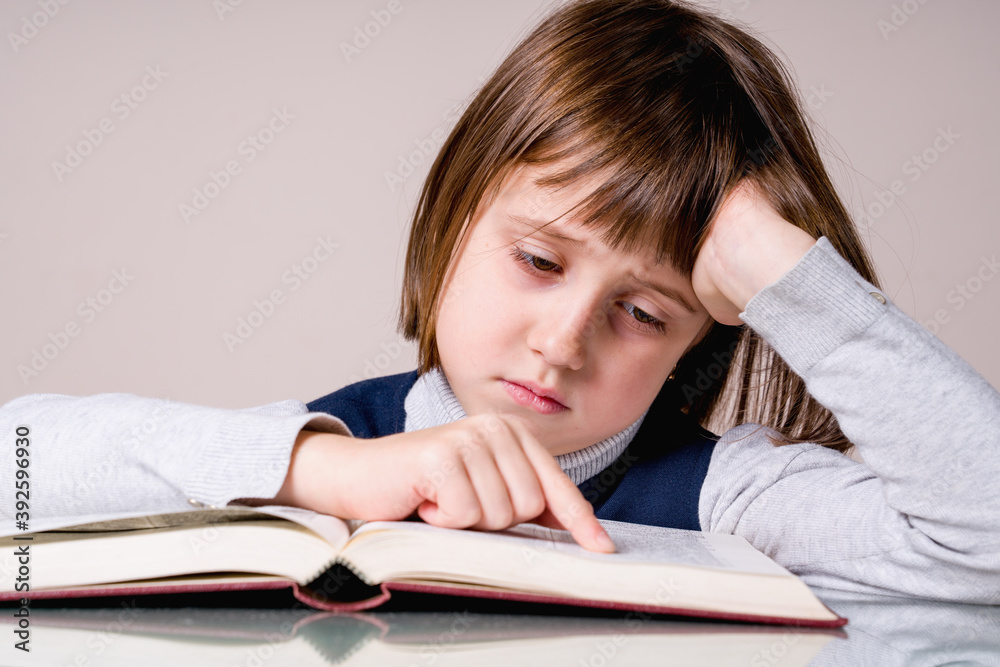 Young child girl stressed by the learning. She was very tired to do homework. Young child girl stressed by the learning. She was very tired to do homework.
