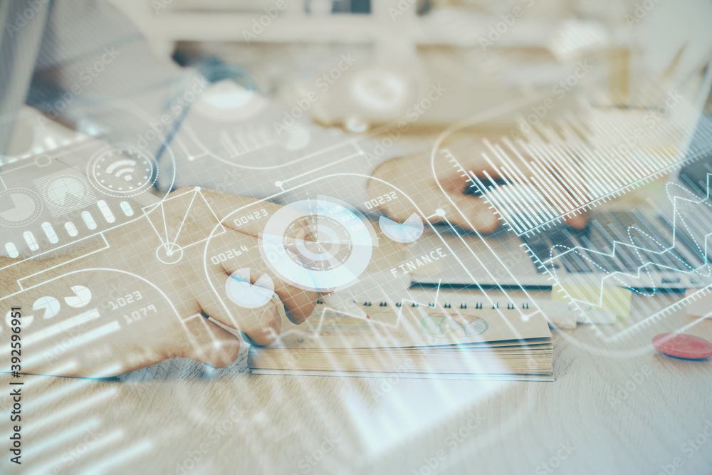 Technology theme hologram with man working on computer on background. High tech concept. Double exposure.
