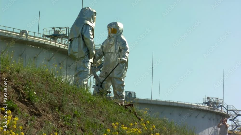 People in protective suits People in protective suits