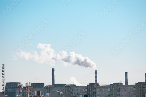  Copy space with industrial chimneys with smoke on blue sky background. Smokestack Pollution in the air as environmental problem