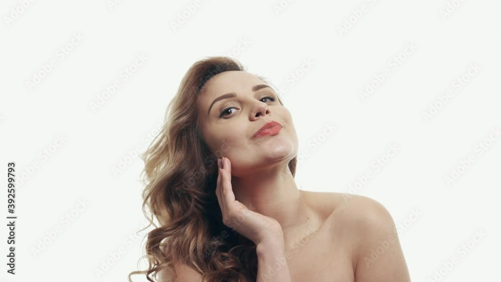 Young woman dreamily ponders on a white background, close-up. Young woman dreamily ponders on a white background, close-up.