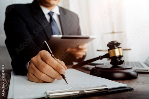 Fototapeta Naklejka Na Ścianę i Meble -  justice and law concept.Male judge in a courtroom on wooden table and Counselor or Male lawyer working in office. Legal law, advice and justice concept.