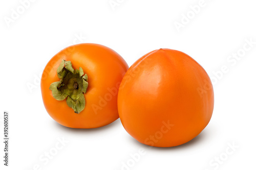 Two ripe persimmon fruit isolated on white background.