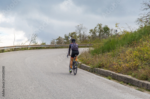 cyclist rides on the road to Crater of volcano Vesuvius, Italy Naples