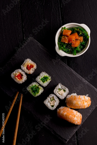 Sushi Set sashimi and sushi rolls on stone slate