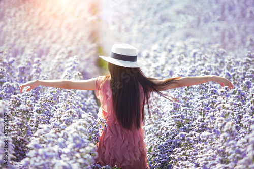 Happy women Walking in the vast multicolored flower fields in the morning