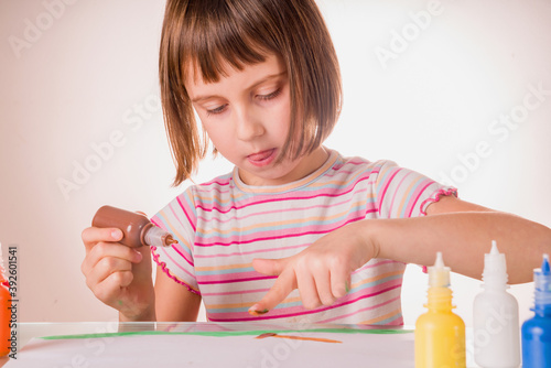 Portrait of young beautiful girl painting a picture in home studio.