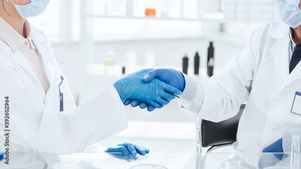 close up. Microbiology scientists shaking hands. science and health.