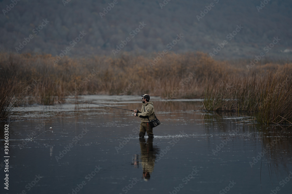 portrait of fisherman in the lake at sunset portrait of fisherman in the lake at sunset