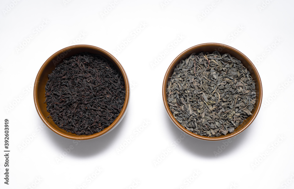 Green and black tea leaves in brown plates , Japanese tea , Sencha, Ryokucha Green and black tea leaves in brown plates , Japanese tea , Sencha, Ryokucha