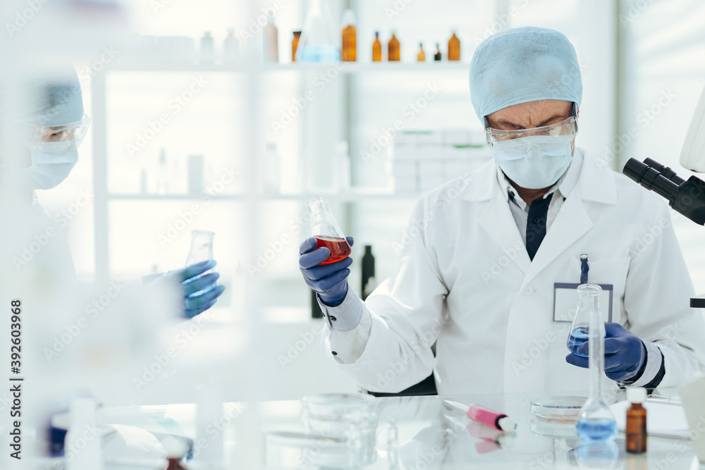 Fototapeta premium scientists colleagues checking the liquid in laboratory flasks.