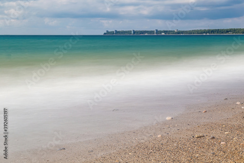 Silky sea water with the original shot on the beach