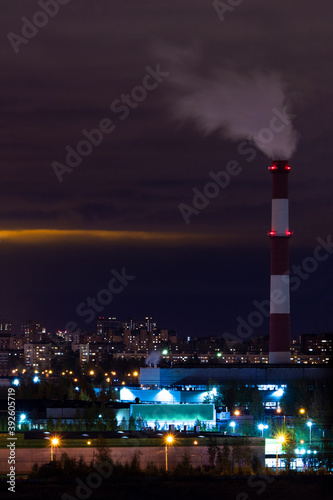 Night landscape with a Smoking chimney on the industrial outskirts of a megalopolis in Russia
