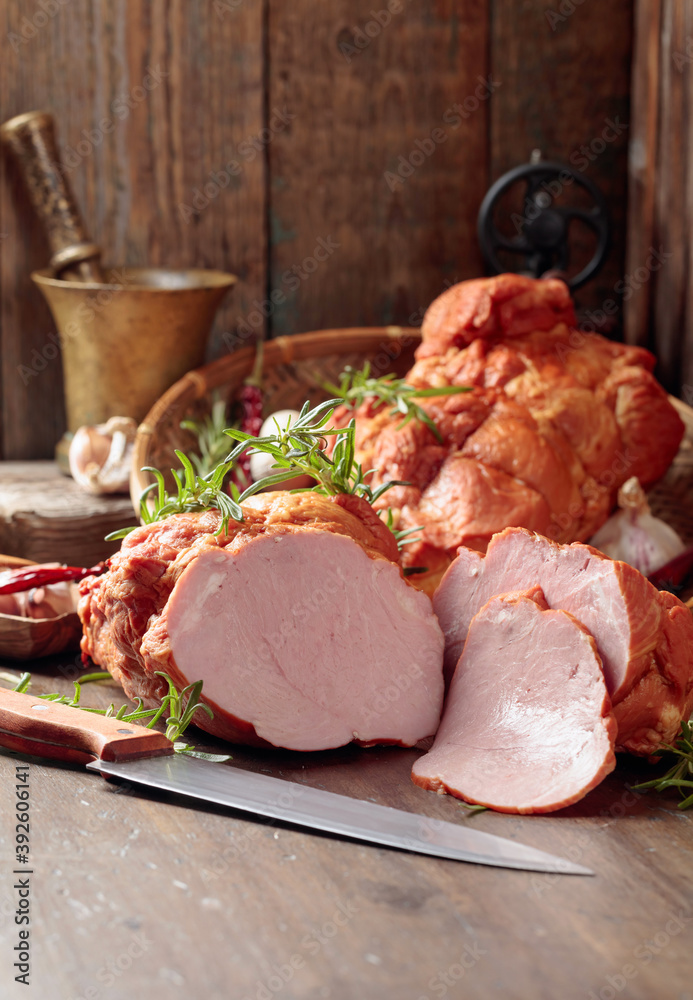 Smoked ham on an old wooden table.