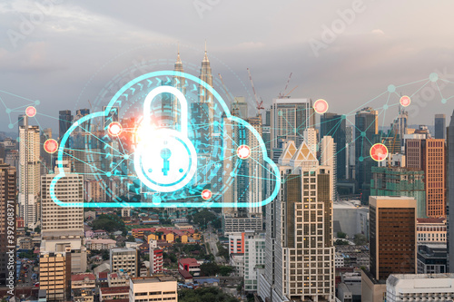 Hologram of Padlock on sunset panoramic cityscape of Kuala Lumpur, Malaysia, Asia. The concept of cyber security intelligence in KL. Multi exposure.