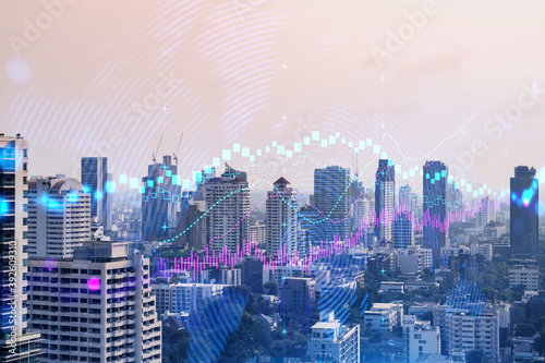 Forex and stock market chart hologram over panorama city view of Bangkok  the financial center in Asia. The concept of international trading. Double exposure.
