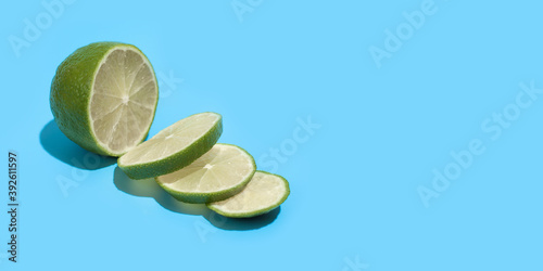 Ripe juicy delicious lime on blue background. Healthy eating and dieting concept. Copy space. Free space for your text