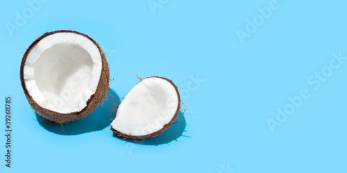 Fresh juicy coconut isolated on a blue background. Concept of Healthy eating and dieting. Travel and holiday concept. Copy space. Free space for your text