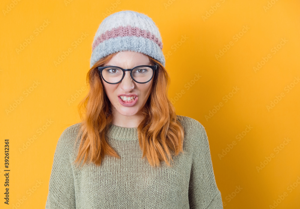 Aggressive young woman screaming, isolated on yellow background. Frustrated pretty woman Aggressive young woman screaming, isolated on yellow background. Frustrated pretty woman